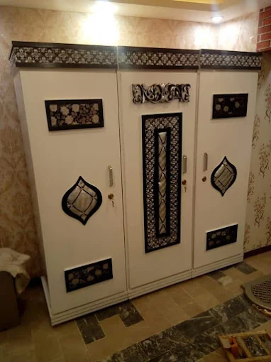 Decorative steel wardrobe with ornamental panels and handles by Al Razzaq