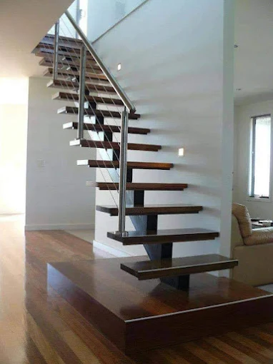Modern steel floating staircase with glass railing by Al Razzaq Grill Works