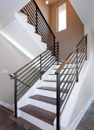 Modern steel railing with wooden handrail by Al Razzaq Grill Works
